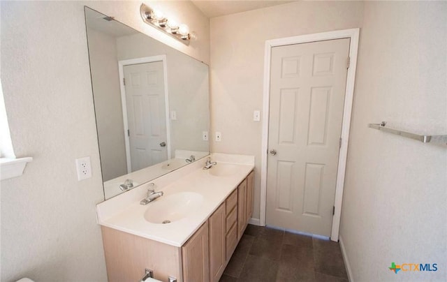 2705 Haven Dr, Killeen, TX 76543 - full bathroom featuring double vanity and baseboards