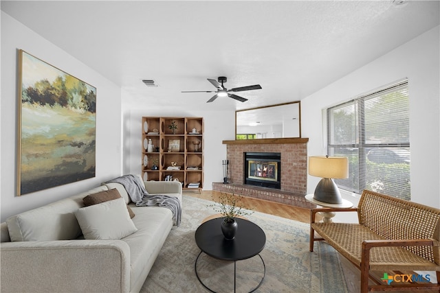218 Gruene Rd, New Braunfels, TX 78130 - living room with wood finished floors, ceiling fan, and a brick fireplace