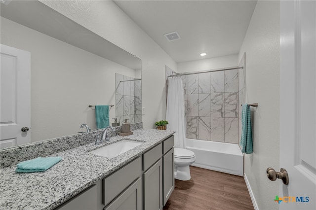 full bathroom featuring shower / bath combination with curtain, wood-type flooring, toilet, and vanity