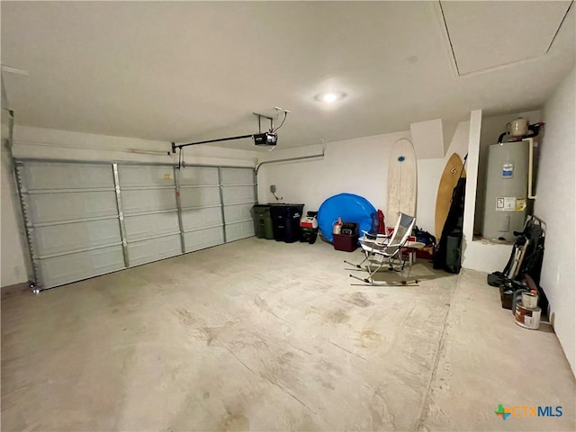 garage with a garage door opener and electric water heater