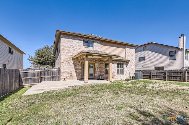 rear view of house featuring a patio, brick siding, central AC unit, and a fenced backyard