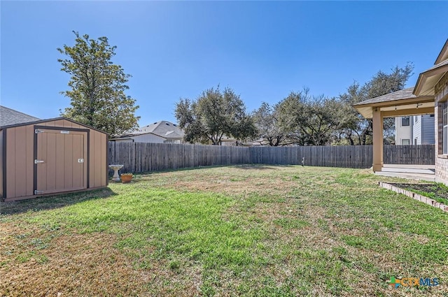 view of yard featuring a fenced backyard, an outdoor structure, and a shed