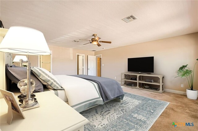 bedroom featuring visible vents, carpet flooring, baseboards, and a ceiling fan
