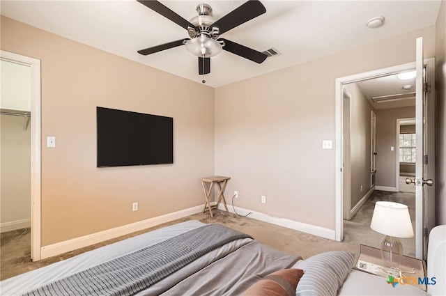 carpeted bedroom featuring a ceiling fan, baseboards, visible vents, and attic access