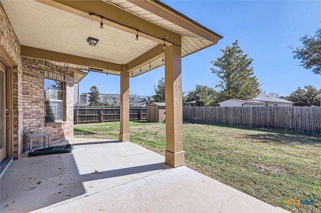view of patio featuring a fenced backyard, an outdoor structure, and a shed