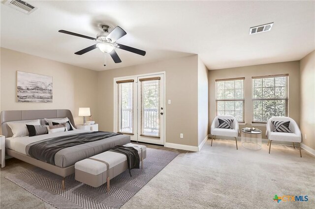 bedroom with visible vents, baseboards, carpet floors, and access to outside