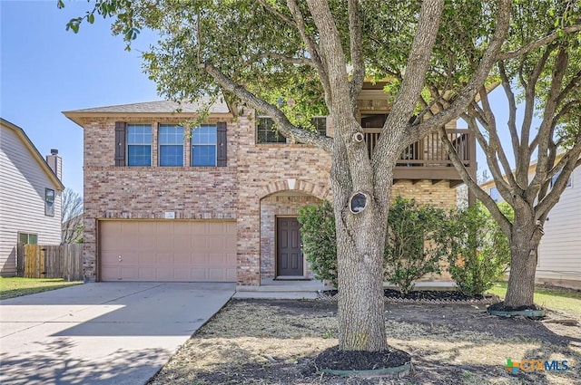 view of front of home featuring an attached garage, a balcony, brick siding, fence, and driveway