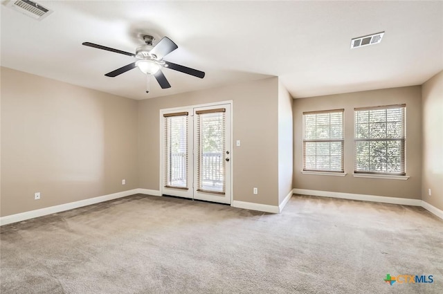 spare room featuring visible vents, carpet flooring, and baseboards