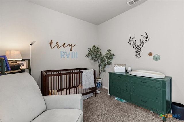 carpeted bedroom with visible vents and a nursery area