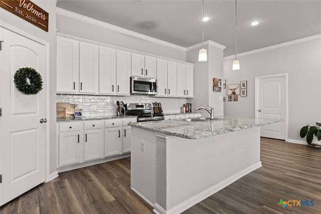 kitchen with dark wood-type flooring, a sink, backsplash, white cabinetry, and appliances with stainless steel finishes