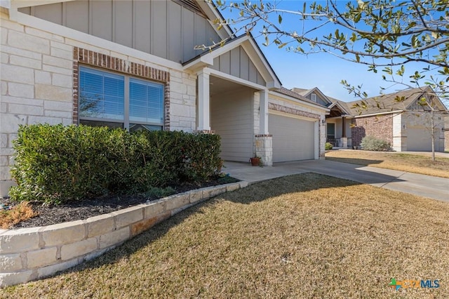 exterior space with brick siding, board and batten siding, driveway, and a garage