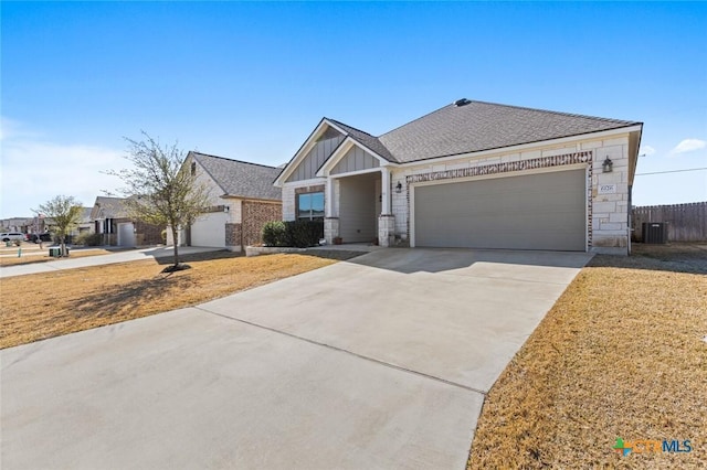 view of front of property with central AC unit, driveway, an attached garage, a front lawn, and board and batten siding