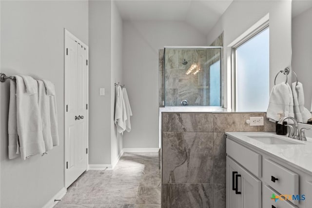 bathroom with lofted ceiling, a stall shower, and vanity