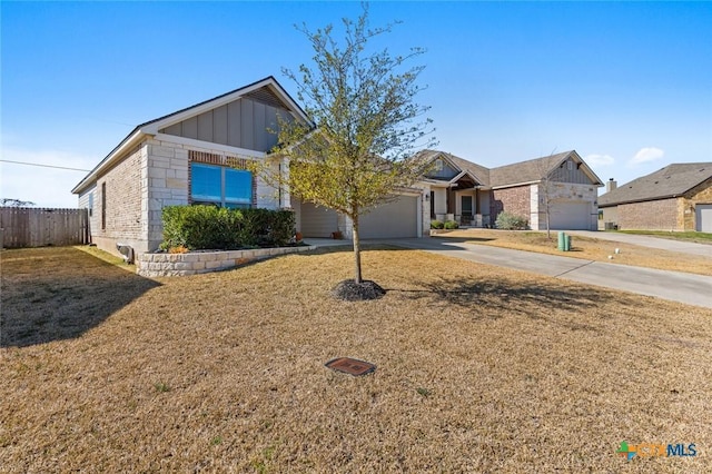 view of front of property featuring board and batten siding, a front lawn, fence, concrete driveway, and an attached garage