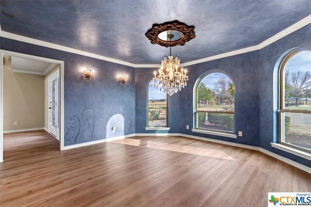 6503 Wells Fargo Rd, Killeen, TX 76542 - unfurnished dining area featuring wood finished floors, a chandelier, and baseboards
