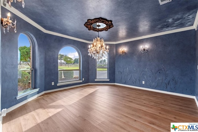 interior space with ornamental molding, hardwood / wood-style floors, and a chandelier