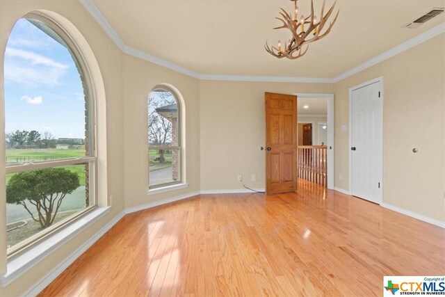 6503 Wells Fargo Rd, Killeen, TX 76542 - unfurnished room with light wood-style floors, a chandelier, ornamental molding, and baseboards