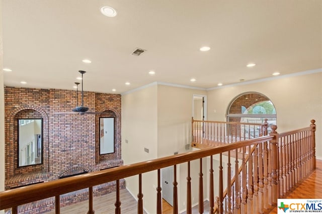 hall featuring light wood-type flooring and crown molding