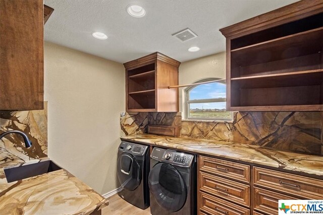 6503 Wells Fargo Rd, Killeen, TX 76542 - clothes washing area featuring cabinet space, washer and dryer, light wood finished floors, recessed lighting, and baseboards
