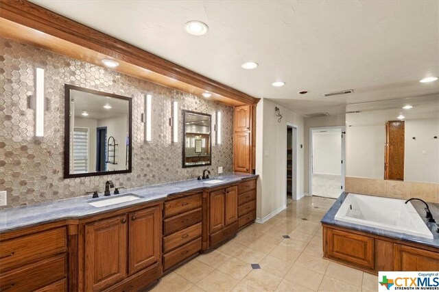 6503 Wells Fargo Rd, Killeen, TX 76542 - full bath with recessed lighting, baseboards, tile patterned flooring, a garden tub, and double vanity