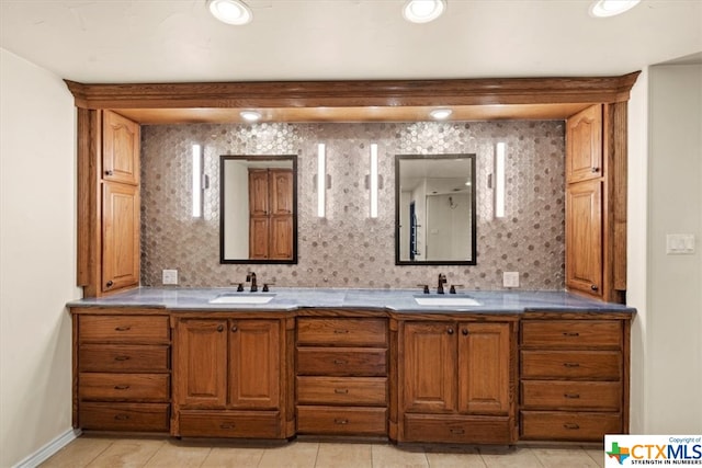 bathroom featuring tasteful backsplash, vanity, and tile patterned flooring