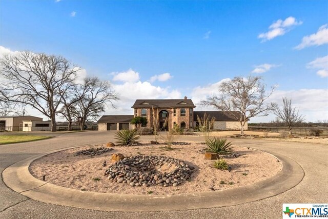 6503 Wells Fargo Rd, Killeen, TX 76542 - view of front facade with curved driveway and a garage