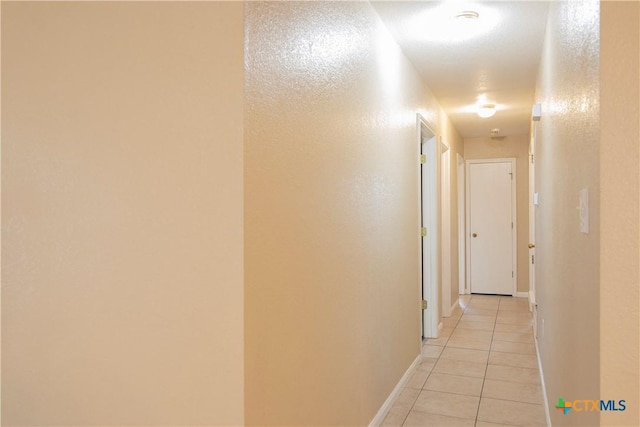 hall with light tile patterned floors