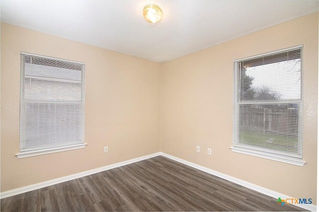 empty room with dark wood-type flooring