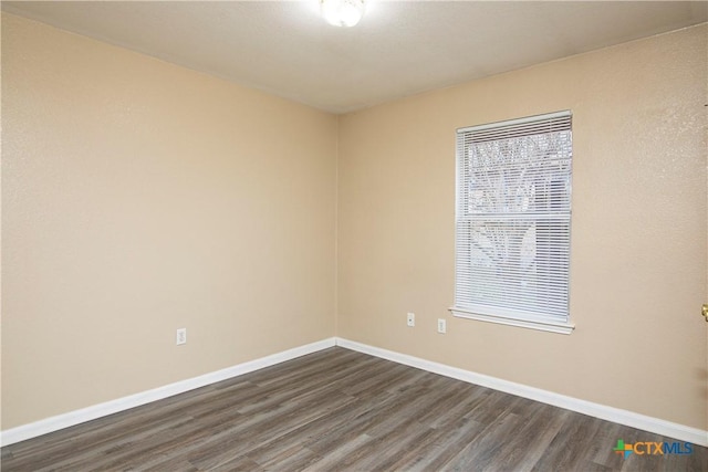 unfurnished room with hardwood / wood-style flooring