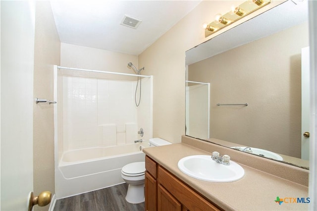 full bathroom with vanity, hardwood / wood-style floors, toilet, and washtub / shower combination