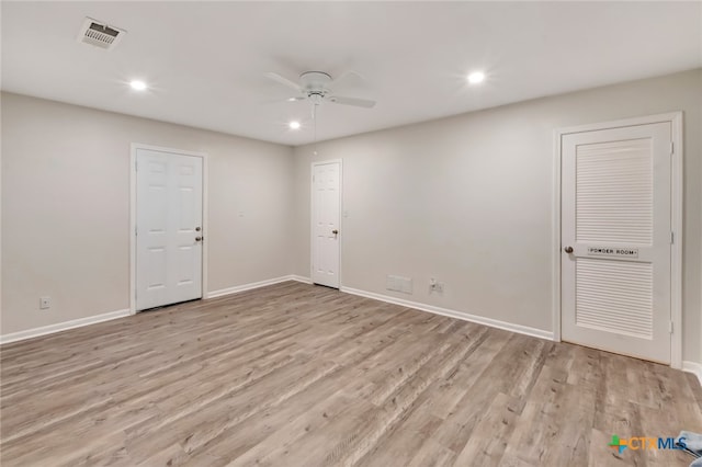 empty room featuring ceiling fan and light hardwood / wood-style flooring