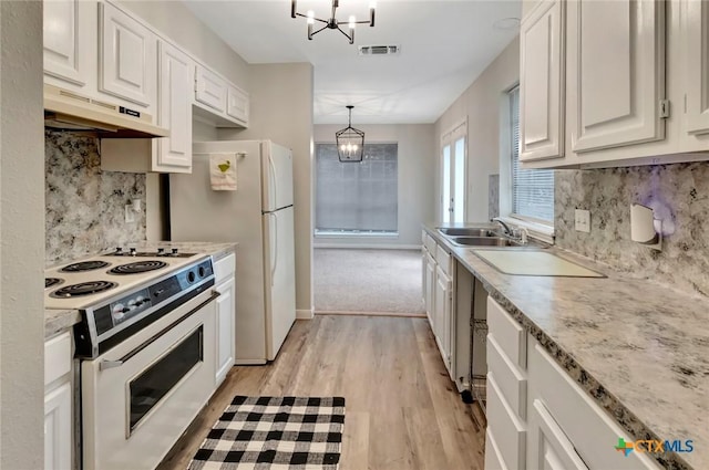 kitchen featuring white cabinets, custom range hood, white appliances, and light wood-type flooring