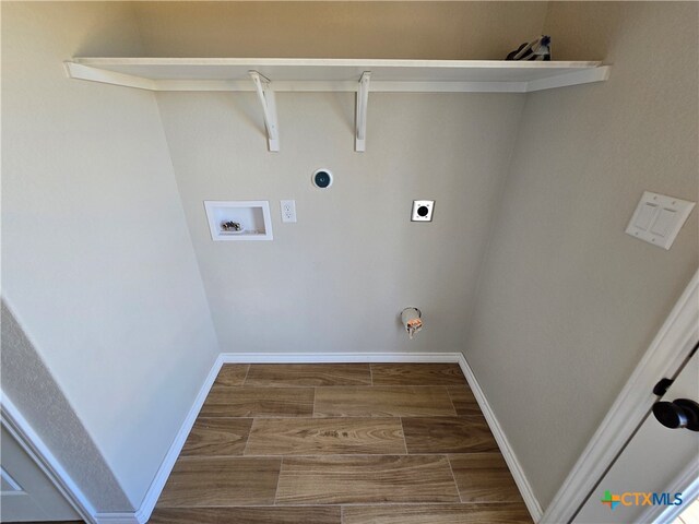 washroom with hookup for an electric dryer, washer hookup, hardwood / wood-style flooring, and hookup for a gas dryer