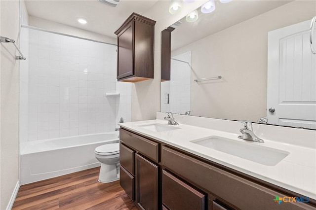 5101 Hacienda Dr, Killeen, TX 76549 - bathroom with toilet, wood finished floors, double vanity, bathing tub / shower combination, and recessed lighting