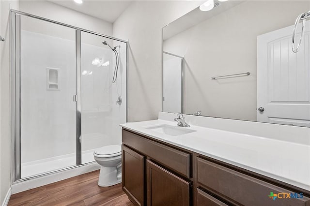 5101 Hacienda Dr, Killeen, TX 76549 - bathroom with a stall shower, toilet, wood finished floors, and vanity