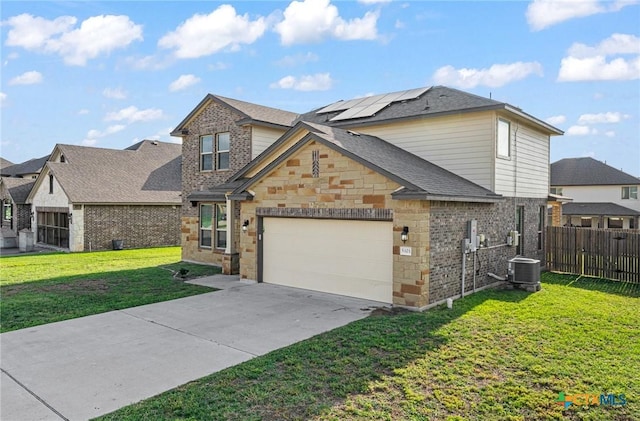 5101 Hacienda Dr, Killeen, TX 76549 - view of front facade with solar panels, an attached garage, driveway, central AC, and brick siding