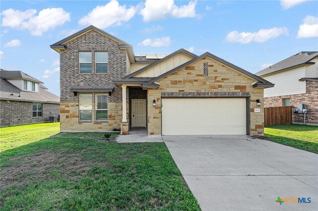 5101 Hacienda Dr, Killeen, TX 76549 - craftsman-style home with a garage, stone siding, roof mounted solar panels, concrete driveway, and board and batten siding