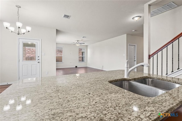 5101 Hacienda Dr, Killeen, TX 76549 - kitchen with a sink, a chandelier, hanging light fixtures, light stone counters, and ceiling fan