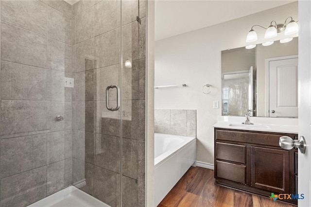 5101 Hacienda Dr, Killeen, TX 76549 - bathroom with a shower stall, a bath, vanity, and wood finished floors
