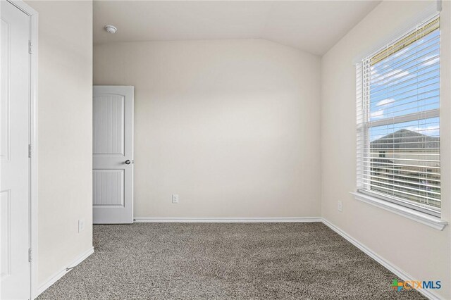 5101 Hacienda Dr, Killeen, TX 76549 - carpeted empty room featuring lofted ceiling, baseboards, and a smoke detector