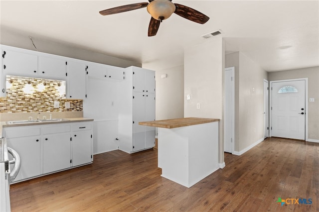2004 Veterans Ave, Copperas Cove, TX 76522 - kitchen with a sink, white cabinets, tasteful backsplash, wood finished floors, and ceiling fan