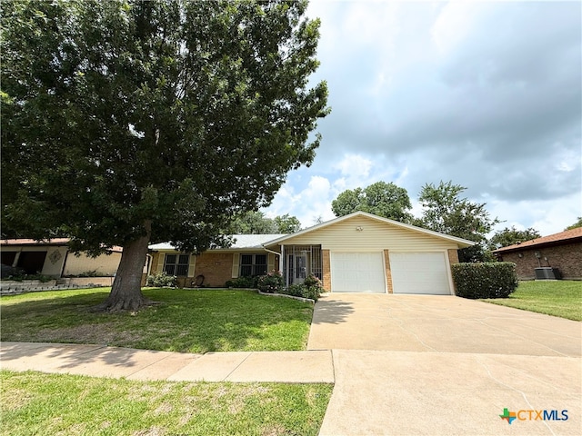 1901 Muir Dr, Killeen, TX 76543 - ranch-style home featuring a garage, concrete driveway, brick siding, and a front yard
