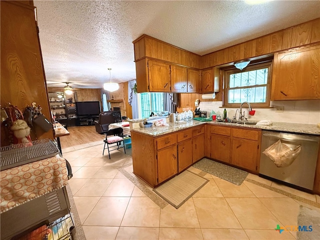 1901 Muir Dr, Killeen, TX 76543 - kitchen with dishwasher, a peninsula, a textured ceiling, brown cabinets, and ceiling fan