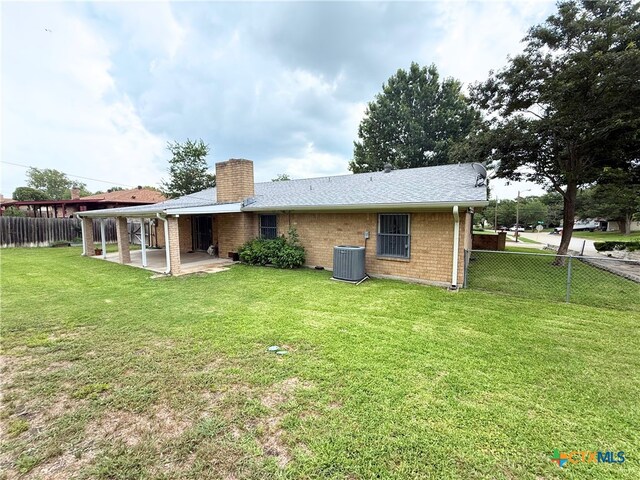 1901 Muir Dr, Killeen, TX 76543 - back of house with a chimney, a patio area, a fenced backyard, and brick siding