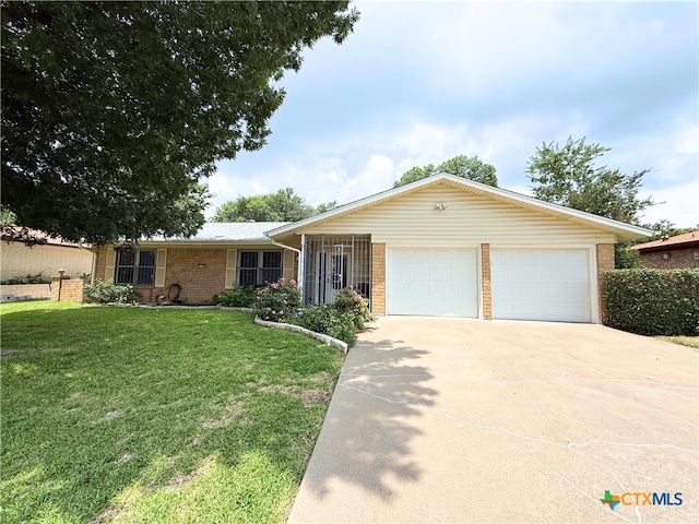 1901 Muir Dr, Killeen, TX 76543 - ranch-style house with brick siding, driveway, a front lawn, and a garage