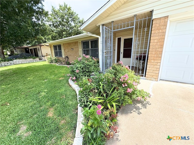1901 Muir Dr, Killeen, TX 76543 - entrance to property featuring brick siding, a yard, a garage, and driveway