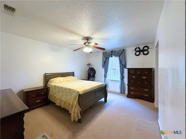 1901 Muir Dr, Killeen, TX 76543 - bedroom with light carpet, a textured ceiling, and a ceiling fan