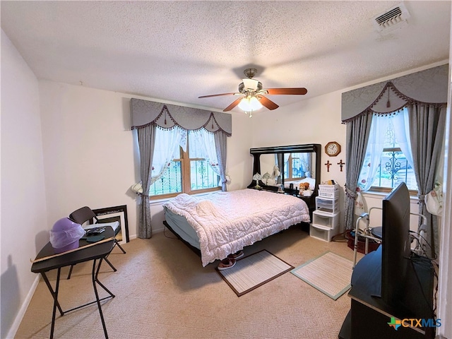 1901 Muir Dr, Killeen, TX 76543 - bedroom featuring multiple windows, a textured ceiling, light colored carpet, and ceiling fan
