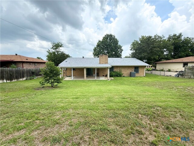 1901 Muir Dr, Killeen, TX 76543 - rear view of house with a patio, a chimney, a fenced backyard, and brick siding