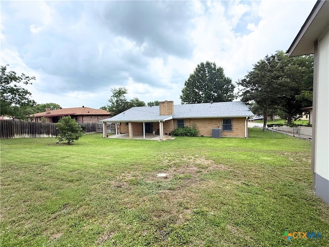 1901 Muir Dr, Killeen, TX 76543 - rear view of house with a patio, a chimney, and brick siding